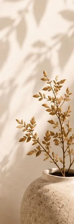 Golden botanical branch in a stoneware vase